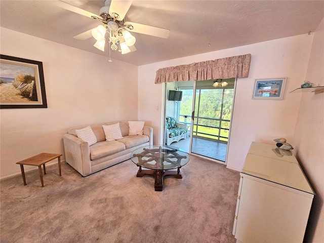 carpeted living room with ceiling fan