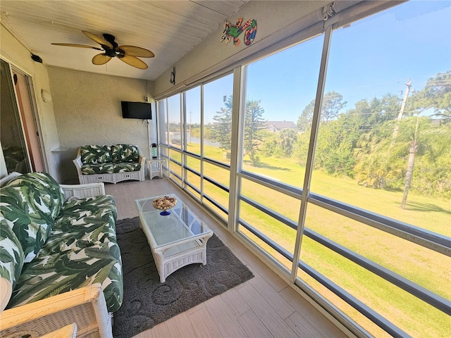 sunroom / solarium with ceiling fan and wooden ceiling