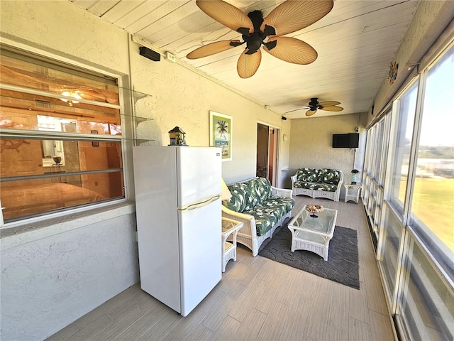 sunroom / solarium featuring ceiling fan and wood ceiling