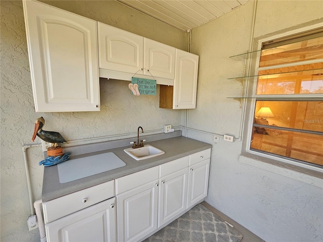 kitchen featuring white cabinets and sink