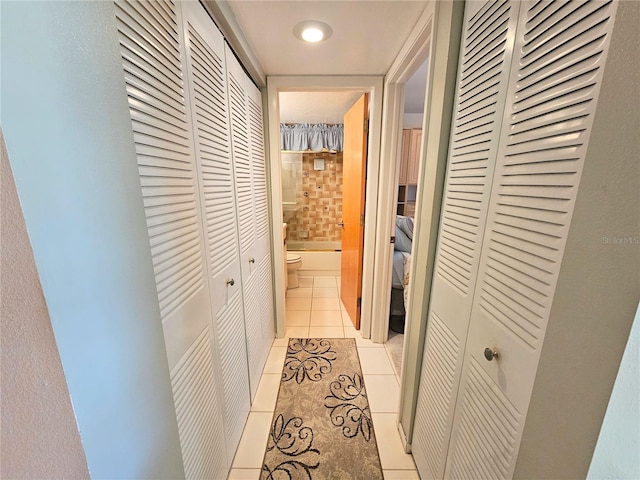 corridor featuring light tile patterned floors