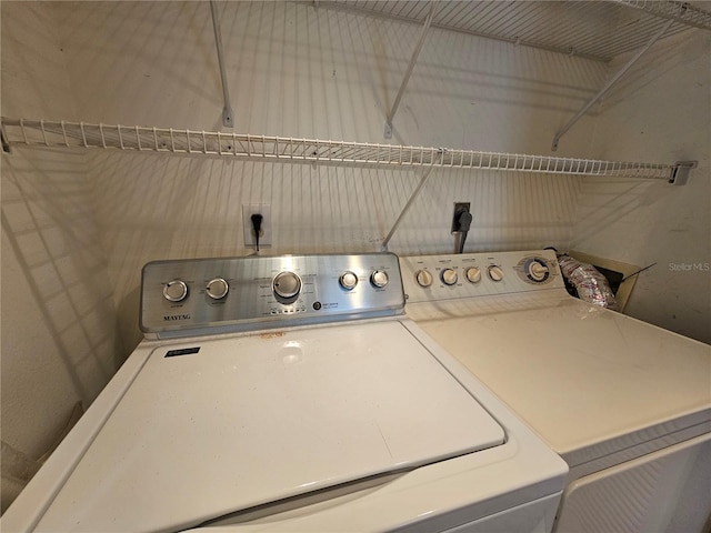 clothes washing area featuring washing machine and clothes dryer