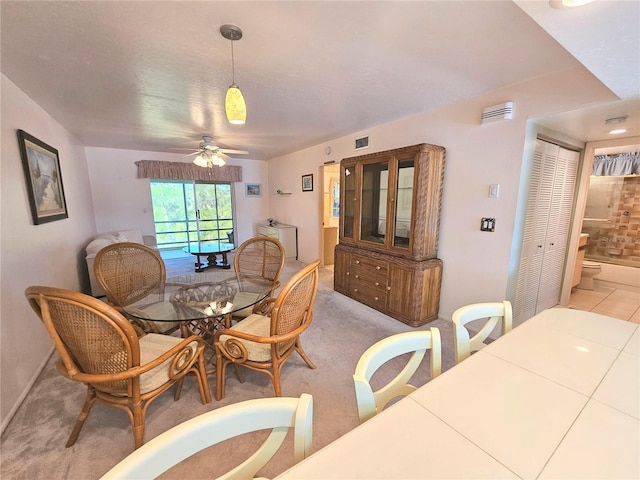 dining space featuring ceiling fan and carpet flooring