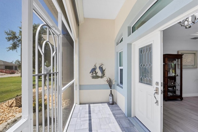 exterior space with a chandelier and dark wood-type flooring