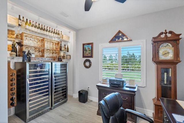 office with indoor bar, wine cooler, light hardwood / wood-style flooring, and ceiling fan