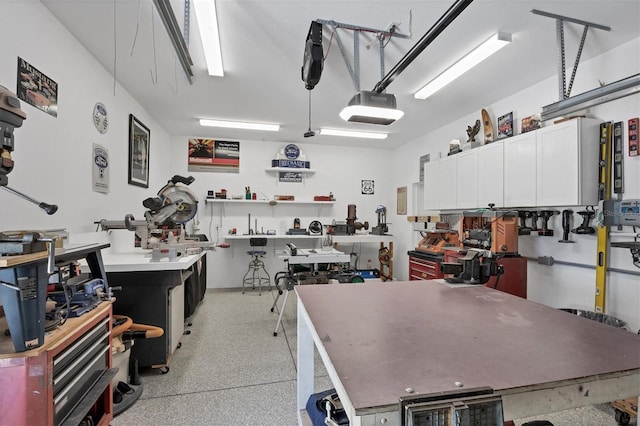 garage with a garage door opener and a workshop area