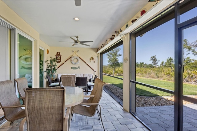 sunroom / solarium featuring a wealth of natural light and ceiling fan