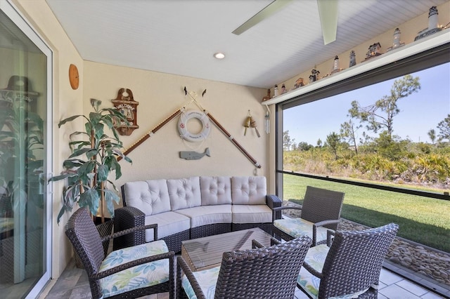 sunroom / solarium featuring ceiling fan