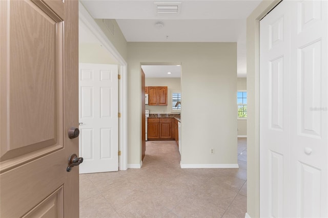 hallway with light tile floors