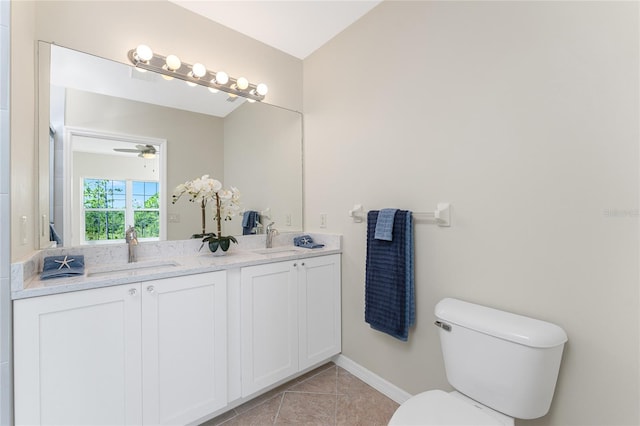 bathroom with toilet, tile flooring, ceiling fan, and double sink vanity