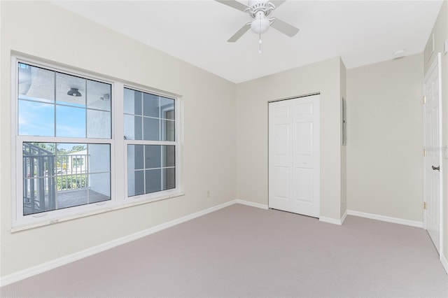 unfurnished bedroom with carpet, ceiling fan, and a closet