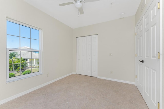 unfurnished bedroom with ceiling fan and light tile floors