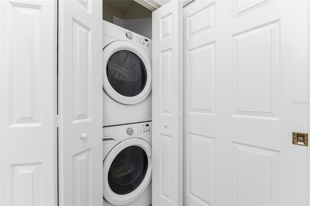 laundry area featuring stacked washer / drying machine