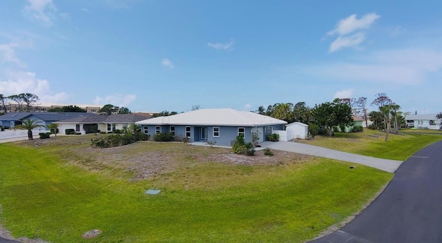 ranch-style house featuring a front yard and driveway