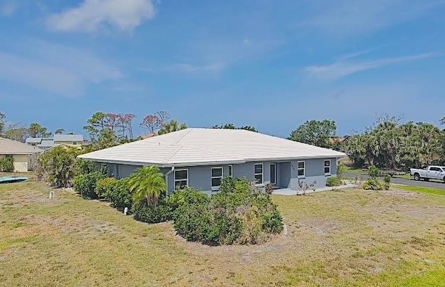 rear view of house featuring a lawn