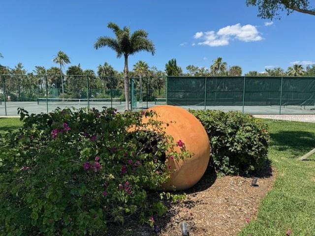 view of community featuring tennis court