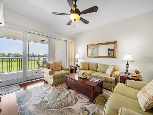 living room with ceiling fan and light hardwood / wood-style floors