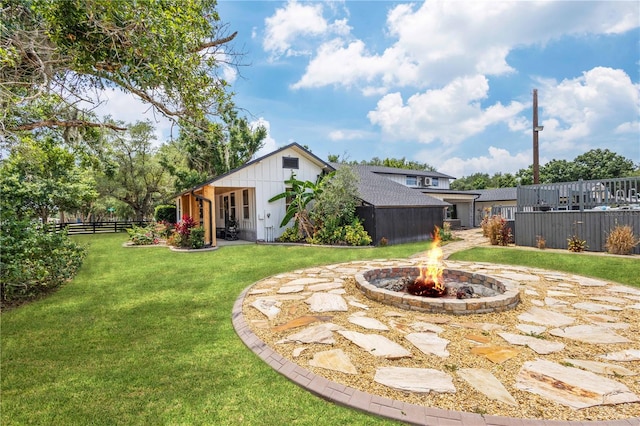 view of yard featuring an outdoor fire pit and a patio