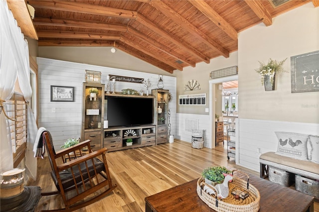 living room with lofted ceiling with beams, light wood-type flooring, and wooden ceiling