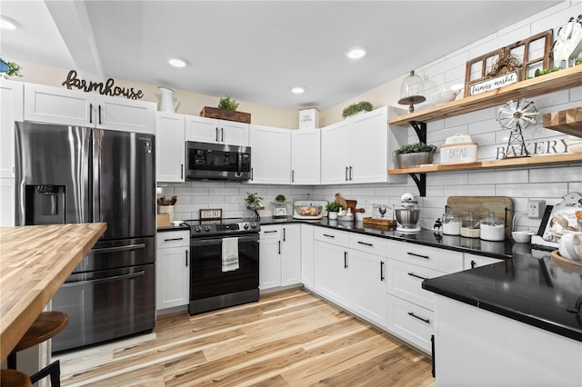 kitchen featuring light hardwood / wood-style flooring, electric range, tasteful backsplash, and refrigerator with ice dispenser