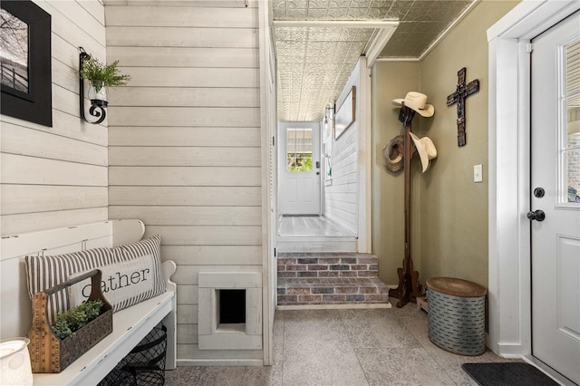 mudroom featuring tile floors and crown molding