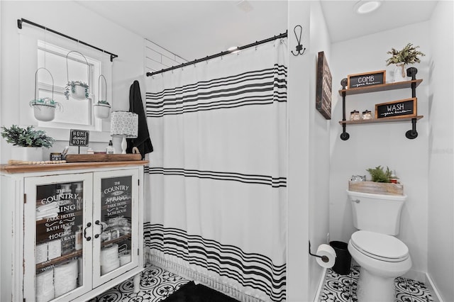 bathroom featuring tile floors, vanity, and toilet