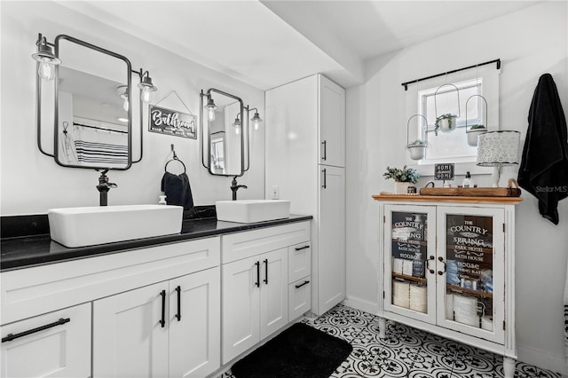 bathroom featuring dual vanity and tile floors