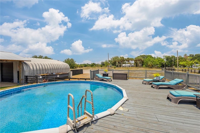 view of swimming pool with a deck