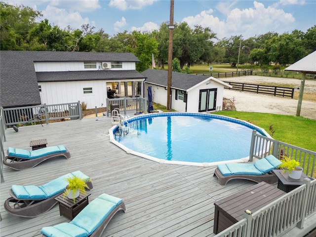 view of swimming pool featuring an outdoor structure and a wooden deck