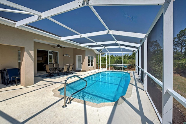 view of swimming pool featuring a patio area, a lanai, and ceiling fan