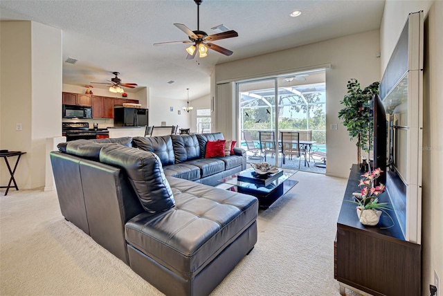 carpeted living room with a textured ceiling and ceiling fan