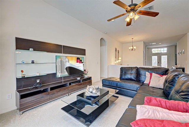 living room featuring carpet and ceiling fan with notable chandelier