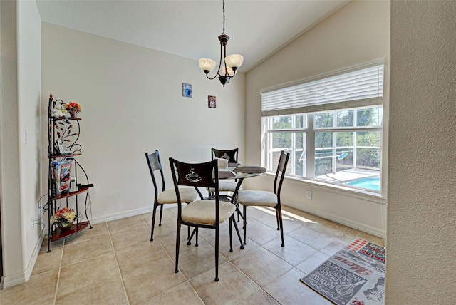 dining area featuring light tile floors, vaulted ceiling, and an inviting chandelier