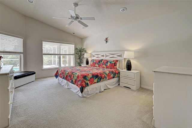 carpeted bedroom featuring vaulted ceiling and ceiling fan