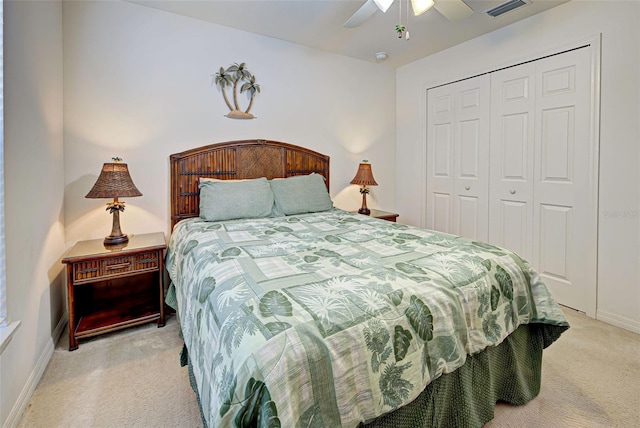 carpeted bedroom with ceiling fan and a closet