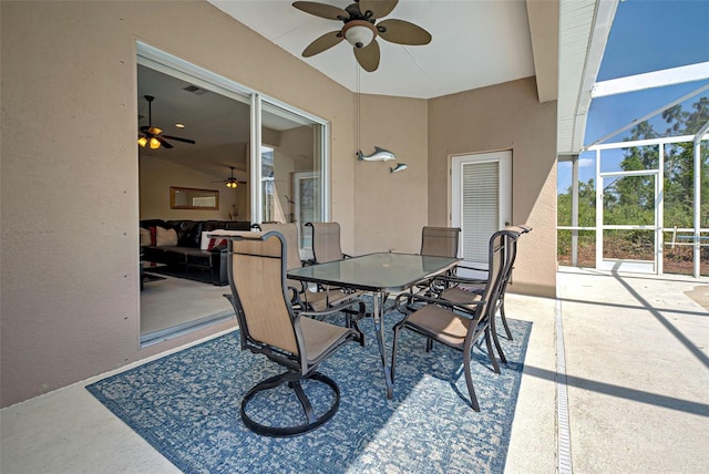 view of terrace featuring ceiling fan and glass enclosure