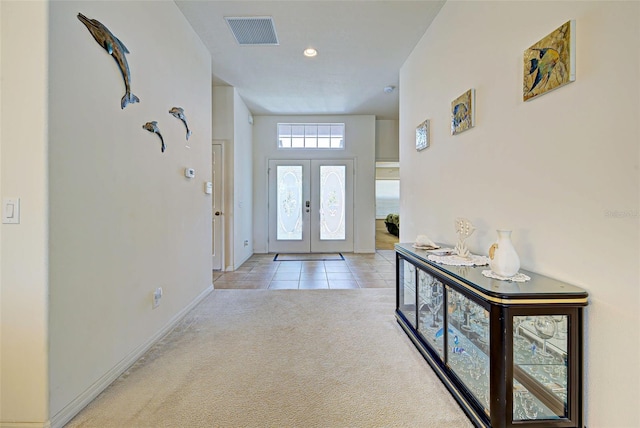 carpeted entryway with french doors