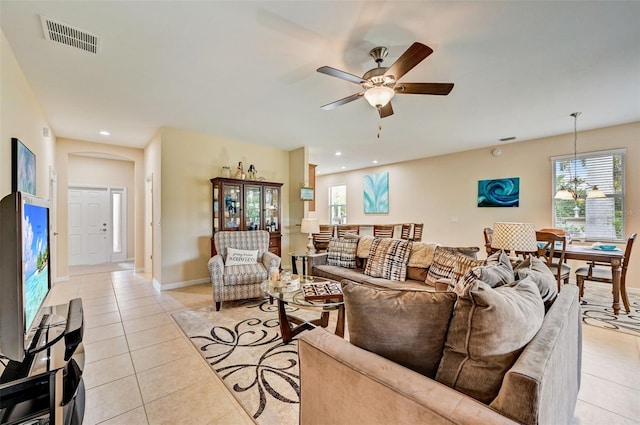 tiled living room featuring ceiling fan