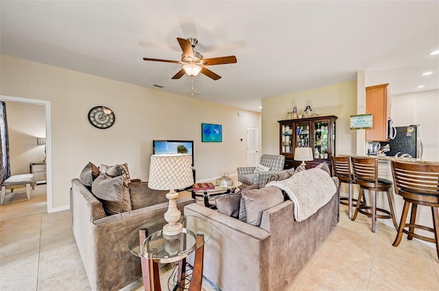 tiled living room featuring ceiling fan