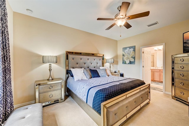 carpeted bedroom featuring ensuite bath and ceiling fan