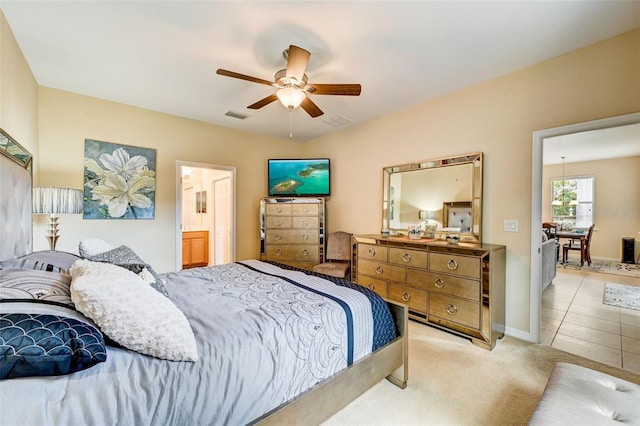 tiled bedroom with ceiling fan and ensuite bathroom