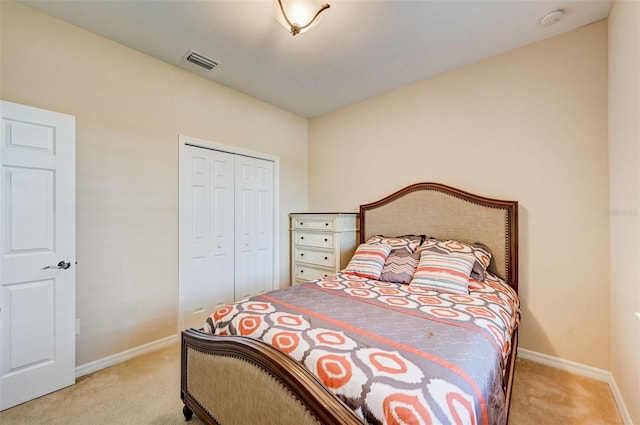 bedroom featuring light carpet and a closet