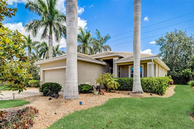 view of front of house with a front lawn and a garage