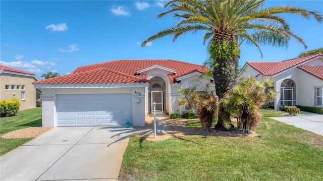 mediterranean / spanish house featuring a front yard and a garage