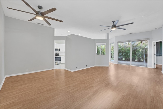 unfurnished living room with light wood-type flooring and ceiling fan