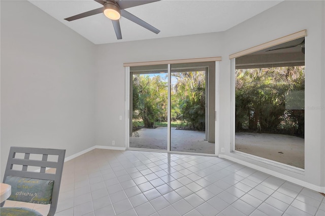 unfurnished room with light tile patterned floors and ceiling fan