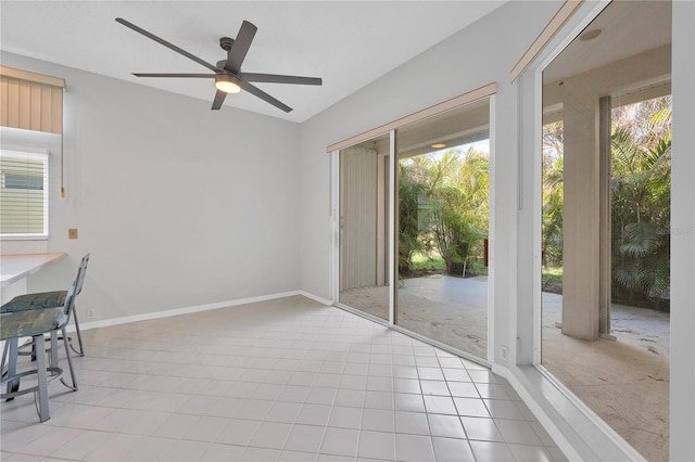 interior space with light tile patterned floors and ceiling fan