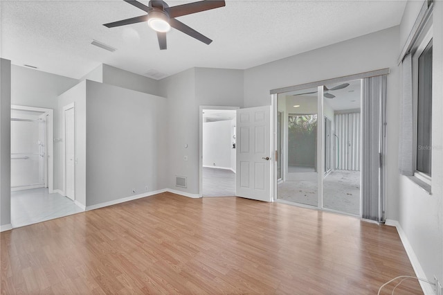 unfurnished bedroom featuring a textured ceiling, light hardwood / wood-style floors, and ceiling fan