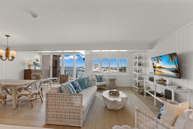 living room featuring light hardwood / wood-style floors and a notable chandelier