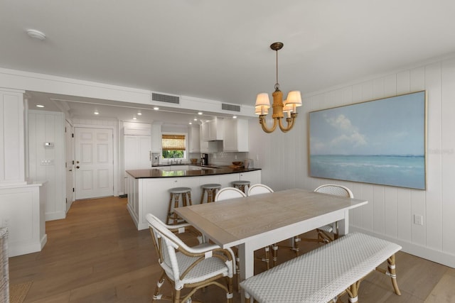 dining area with a notable chandelier and wood-type flooring